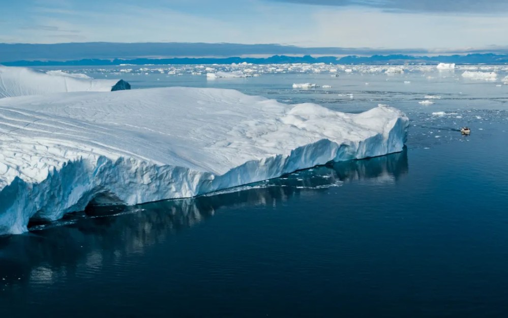 a large body of water with a mountain in the snow