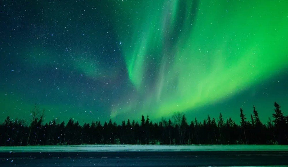 a green and blue sky in the background